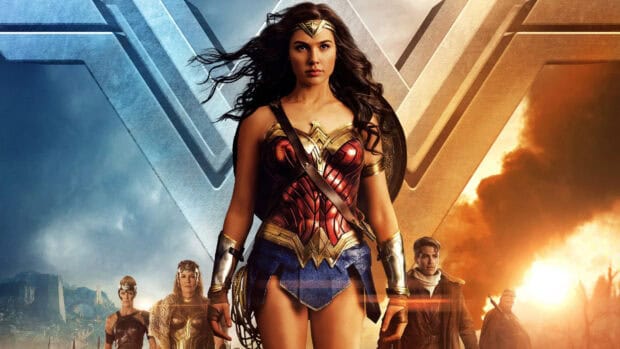 Gal Gadot in Wonder Woman armor standing with allies in front of a burning background, HD Desktop Wallpaper