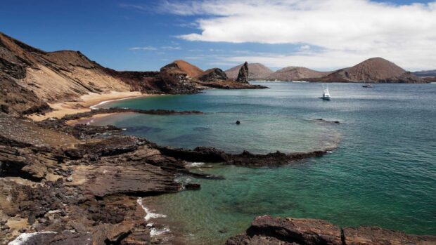 A peaceful coastal view shows the unique rock formations and calm waters of the Galapagos Islands, HD Desktop Wallpaper