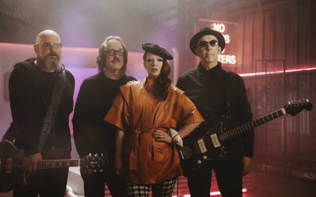The Garbage Band stands together in a stylish indoor setting with guitars, HD Desktop Wallpaper