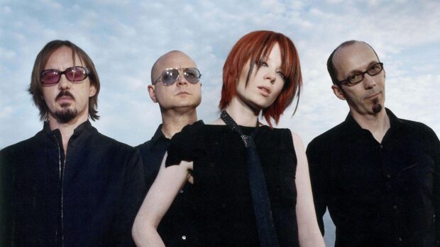 The Garbage Band stands together with a cloudy sky background in this portrait, HD Desktop Wallpaper
