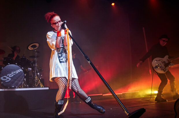 The Garbage Band lead singer performs energetically on stage during a live concert, HD Desktop Wallpaper