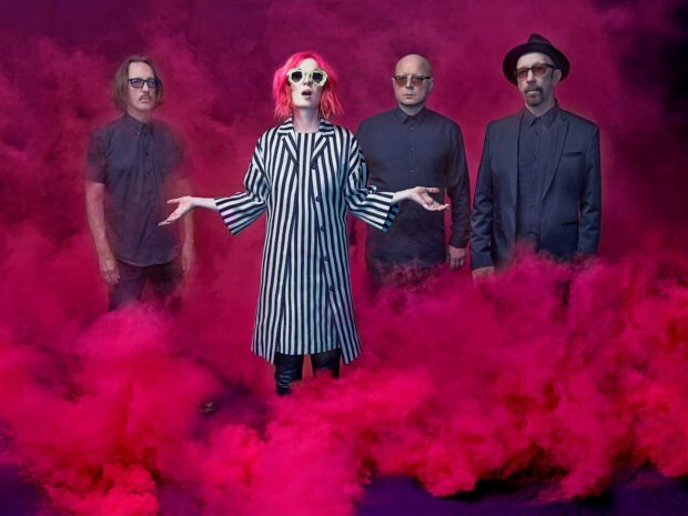 The Garbage Band members stand surrounded by vibrant pink smoke creating a dramatic scene, HD Desktop Wallpaper
