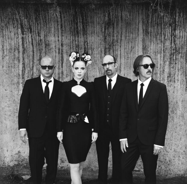 The Garbage Band members stand against a textured wall wearing formal black outfits and sunglasses, HD Mobile Wallpaper