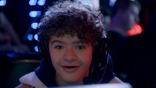 Gaten Matarazzo wearing headphones and speaking into a microphone with blue lights in the background, 4K Desktop Wallpaper