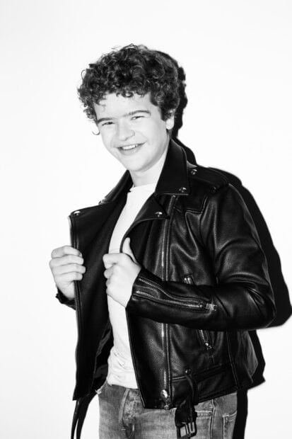 Gaten Matarazzo is smiling while wearing a leather jacket and jeans, HD Desktop Wallpaper