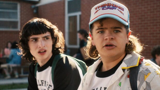 Gaten Matarazzo is seen wearing a colorful jacket and cap outdoors, HD Desktop Wallpaper