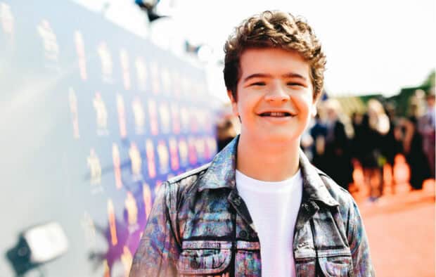 Gaten Matarazzo smiles brightly wearing a patterned jacket at a public event, HD Desktop Wallpaper