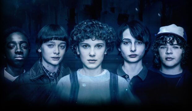 Gaten Matarazzo and friends stand together in a dark setting, 2K Desktop Wallpaper