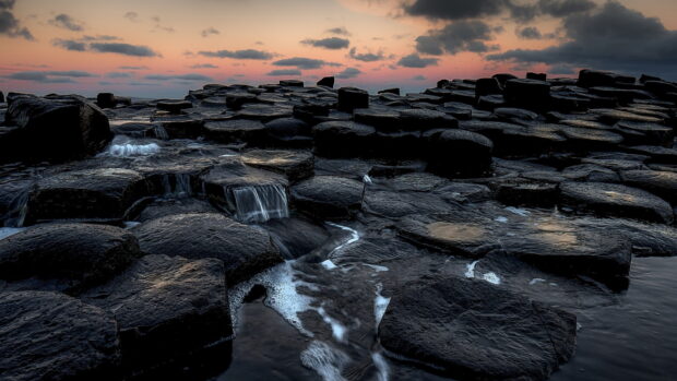 The Giants Causeway showcases unique hexagonal basalt columns with gentle water flow and a colorful sky, HD Desktop Wallpaper