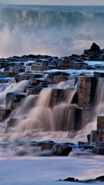 Waves cascading over the unique Giants Causeway rock formations at sunset, HD Mobile Wallpaper