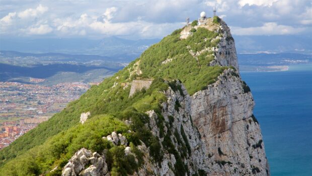 Gibraltar Rock overlooks the city and sea under a partly cloudy sky, 2K Desktop Wallpaper