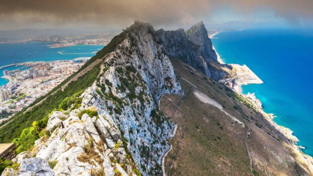 The Gibraltar Rock shows its steep cliffs overlooking the sea and town in this Gibraltar Wallpapers, HD Desktop Wallpaper
