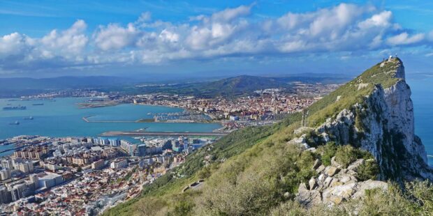 A scenic view of Gibraltar city overlooking the rock and coastline under a blue sky, HD Desktop Wallpaper