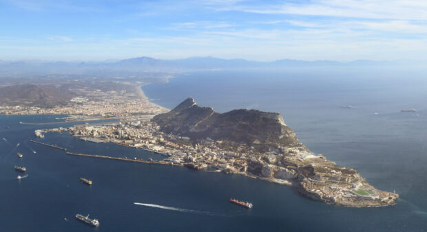 A panoramic view of Gibraltar with sea ships and mountains in the distance, 2K Desktop Wallpaper