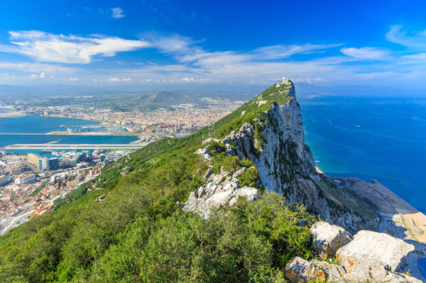 The famous Gibraltar rock overlooks the city and Mediterranean Sea under a blue sky, HD Desktop Wallpaper