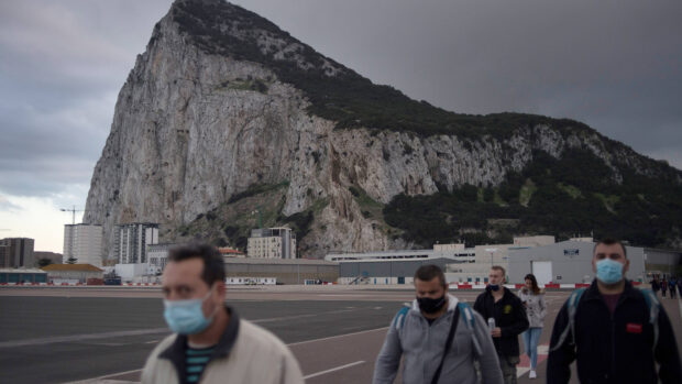 People wearing masks near the Gibraltar rock and buildings, 4K Desktop Wallpaper