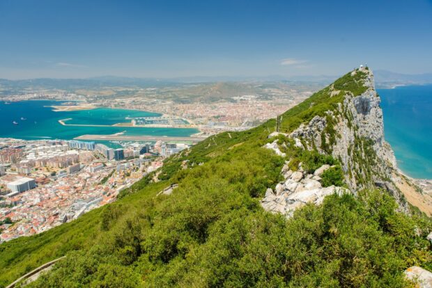 A panoramic view of Gibraltar showing the rock and surrounding city under a clear sky, HD Desktop Wallpaper