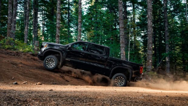 Gmc Sierra driving uphill dirt road in forest area, 4K Desktop Wallpaper