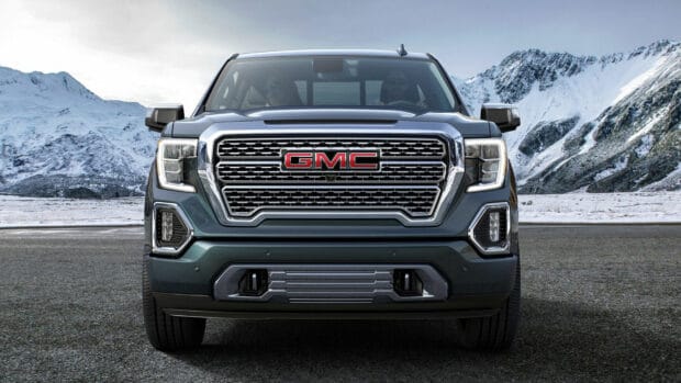 The GMC Sierra truck is shown from the front with snowy mountains in the background, HD Desktop Wallpaper