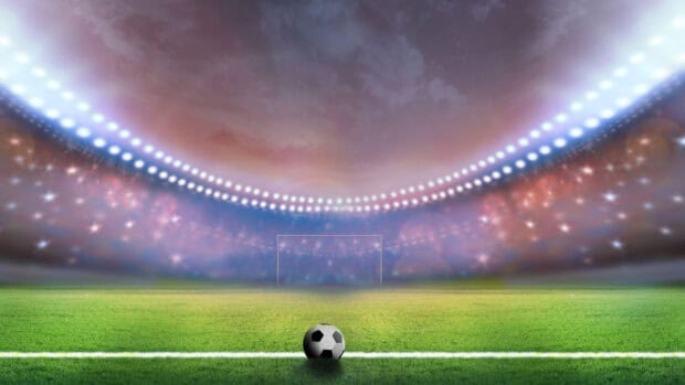 A soccer ball is placed on the grass before the goal under stadium lights in a goal sports wallpapers scene, 4K Desktop Wallpaper