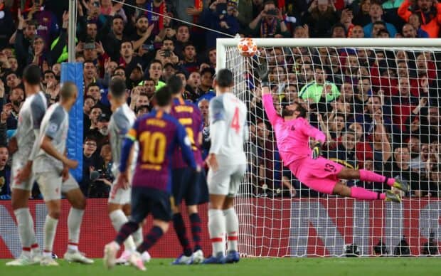 A goalkeeper in pink diving to stop a soccer ball from entering the goal during an intense match, HD Desktop Wallpaper