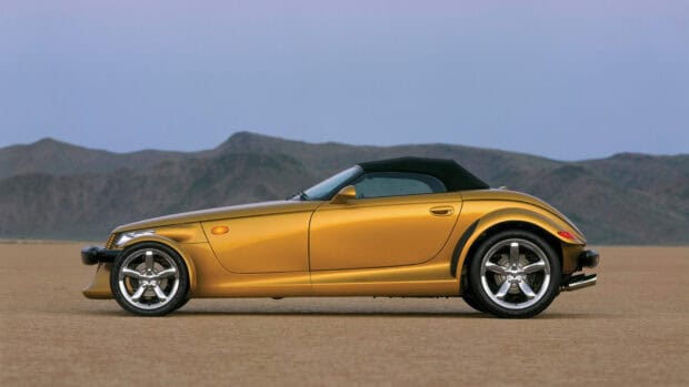 A gold Plymouth Prowler is parked with mountains in the background, HD Desktop Wallpaper