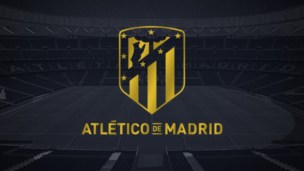The golden Atletico Madrid logo stands prominently in front of an empty stadium at night, HD Desktop Wallpaper