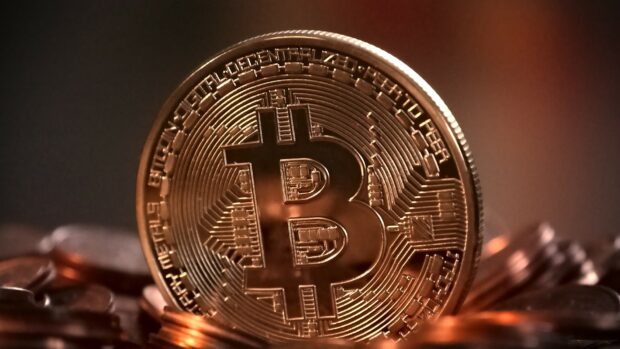A detailed golden Bitcoin coin with circuitry patterns on a dark background, HD Desktop Wallpaper