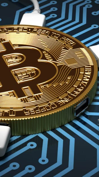 A detailed close up of a golden Bitcoin coin resting on a blue circuit board with connected white cables, 2K Mobile Wallpaper