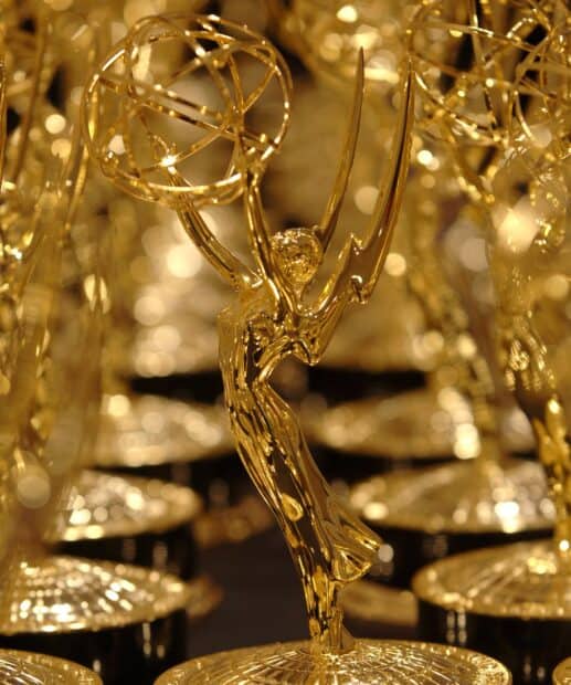 A gold Emmy Awards statuette shines among others in this close up shot, HD Desktop Wallpaper