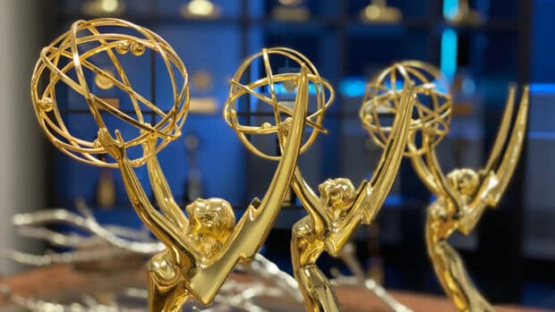 A close up view of golden Emmy Awards trophies with a blurred background, HD Desktop Wallpaper