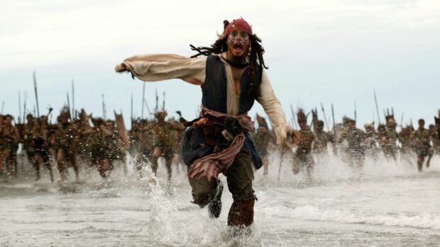A man in costume runs through water with people chasing him, 2K Desktop Wallpaper