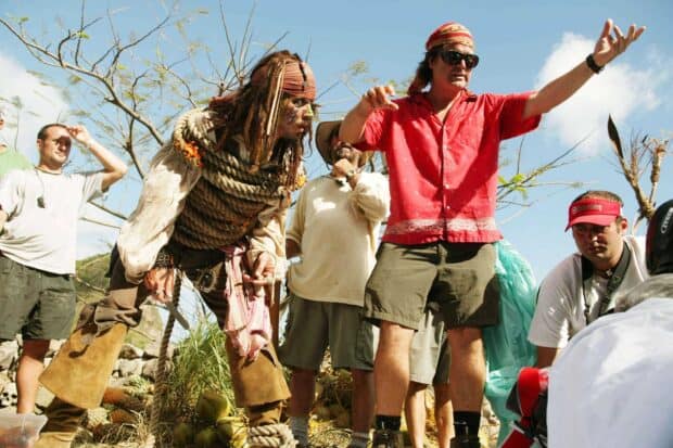 Gore Verbinski is directing a pirate scene outdoors with actors and crew members, 2K Desktop Wallpaper