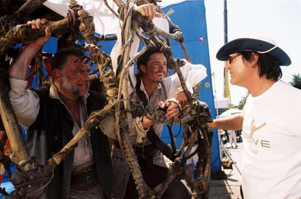 Gore Verbinski is seen directing actors on a pirate movie set with props, 2K Desktop Wallpaper