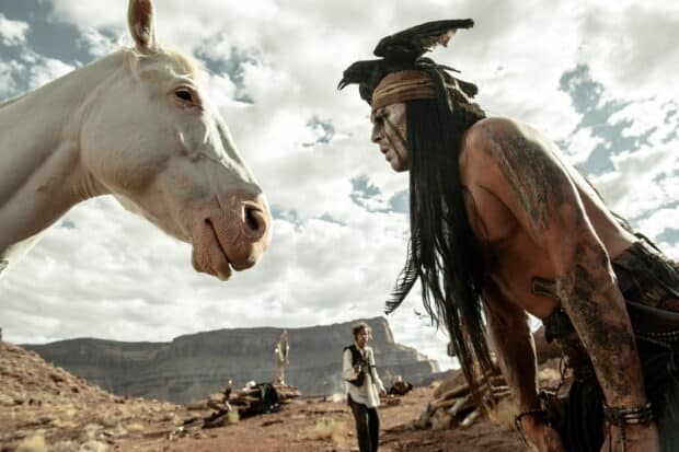 A man with tribal face paint faces a white horse in a desert scene from Gore Verbinski, 2K Desktop Wallpaper