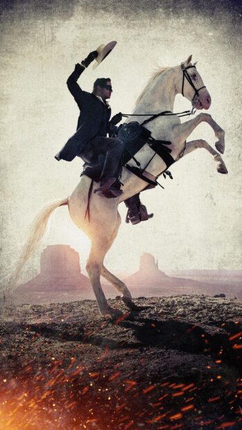 A cowboy rides a white horse rearing with a desert landscape in the background featuring Gore Verbinski, 2K Phone Wallpaper