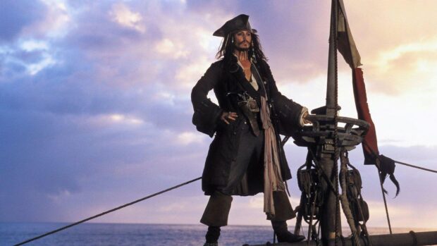 A pirate stands confidently on a ship deck under a cloudy sky, HD Desktop Wallpaper