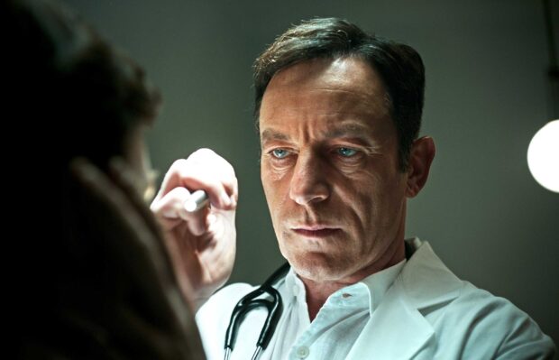 A focused man in a white coat examines a patient with precision in a dramatic setting, 2K Desktop Wallpaper