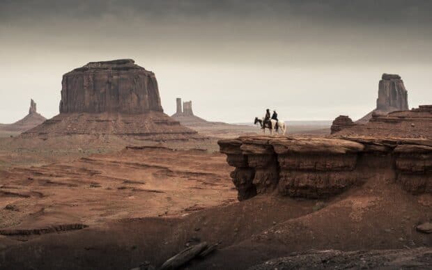 Two riders on horses overlook desert mesas in a Gore Verbinski scene, HD Desktop Wallpaper
