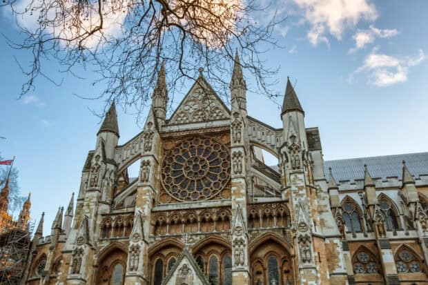 The intricate Gothic architecture of Westminster Abbey is captured under a clear blue sky, HD Desktop Wallpaper