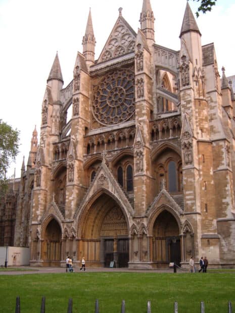 Tourists walking near the historic Westminster Abbey with detailed Gothic architecture, HD Mobile Wallpaper
