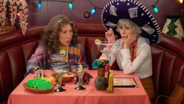 Two women from Grace And Frankie Netflix wallpapers enjoy margaritas at a restaurant booth, HD Desktop Wallpaper