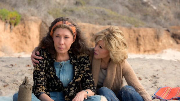 Grace and Frankie share a heartfelt moment on the sandy beach in the Netflix series, 2K Desktop Wallpaper