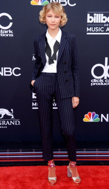 Grace Vanderwaal stands on the red carpet wearing a striped suit and heels at a music awards event, HD Mobile Wallpaper