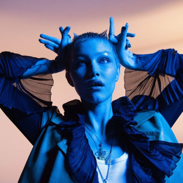 Grace Vanderwaal poses with expressive hands and intense blue lighting, HD Phone Wallpaper