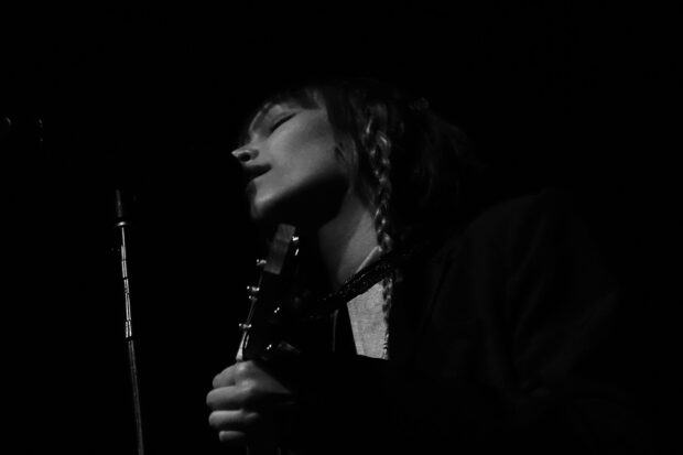 Grace Vanderwaal sings passionately during a live performance holding a guitar, HD Desktop Wallpaper