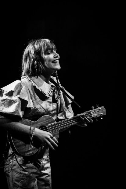 Grace Vanderwaal smiles joyfully while playing her ukulele on stage, HD Phone Wallpaper