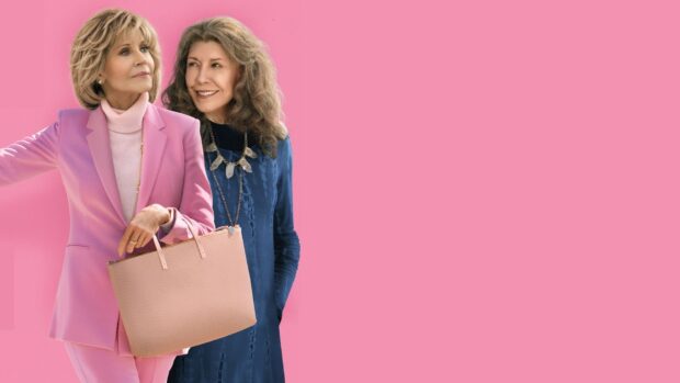 Grace and Frankie stand together with a bright pink background showing their friendship, HD Desktop Wallpaper