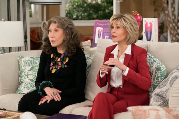 Grace and Frankie watch TV while sitting on a couch in a cozy living room, HD Desktop Wallpaper