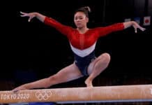 A gymnast in red and blue performs an elegant pose on the balance beam at Tokyo 2020, HD Desktop Wallpaper